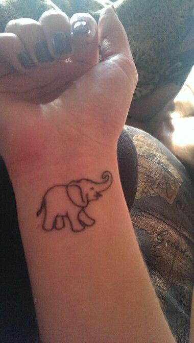 Black Outline Elephant Trunk Up Tattoo On Girl Right Wrist