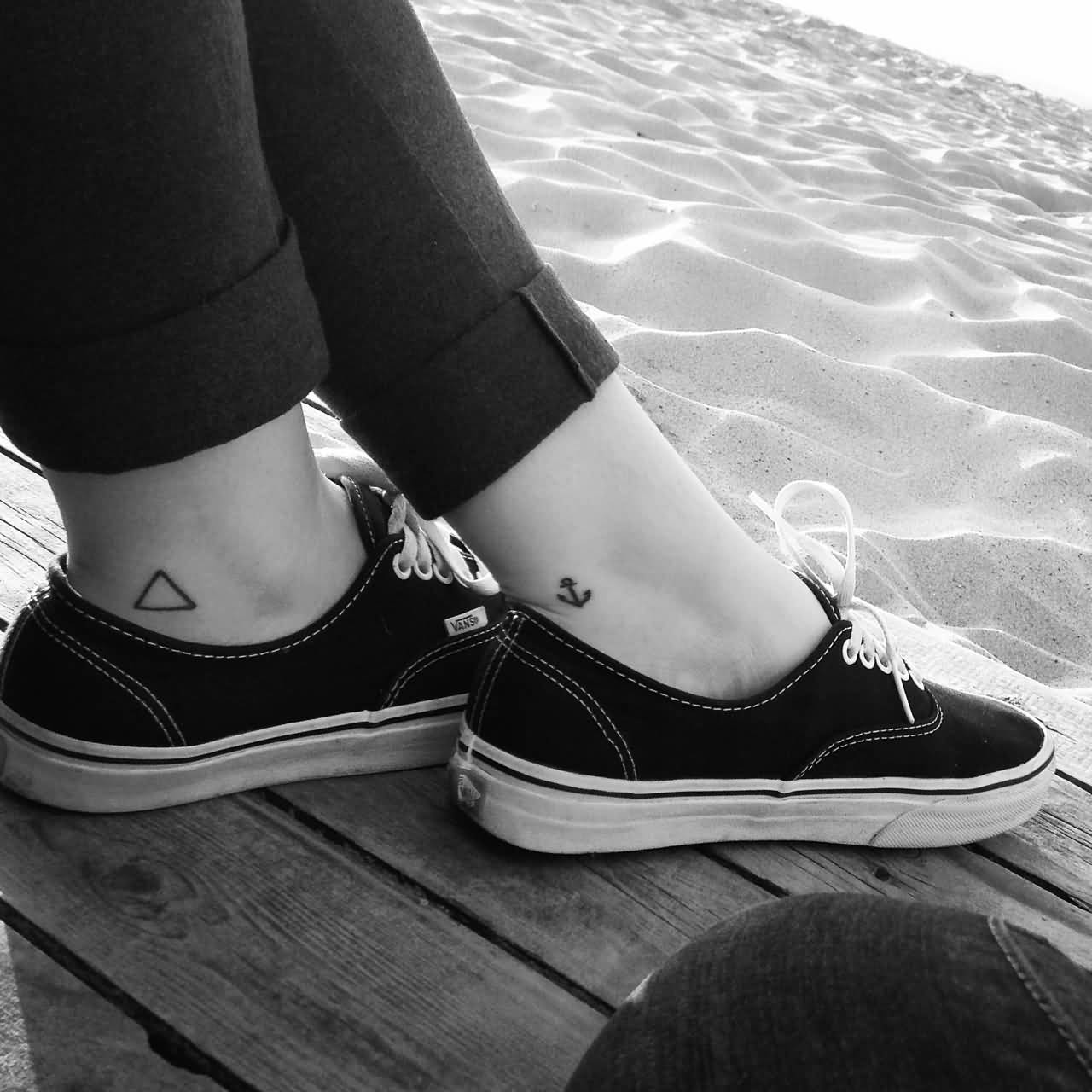 Black Outline Triangle With Anchor Tattoo On Ankle