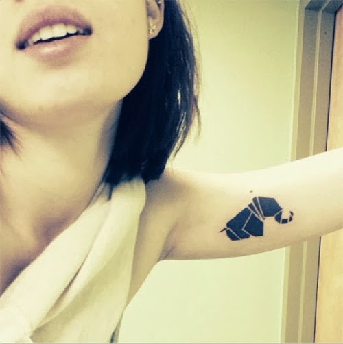 Black Paper Elephant Tattoo On Girl Left Bicep