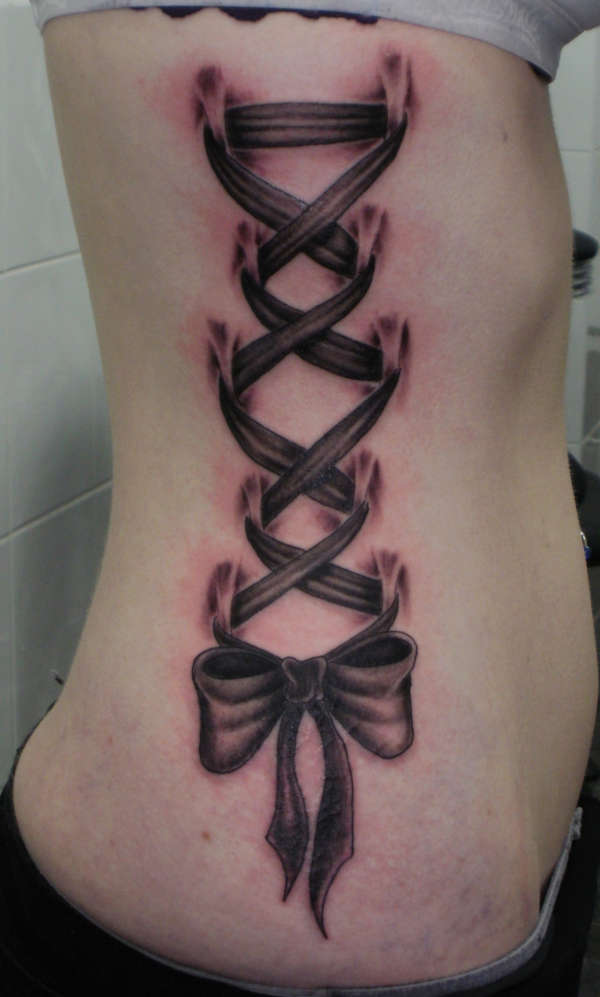 Black Ribbon Corset Tattoo On Side Rib For Girls