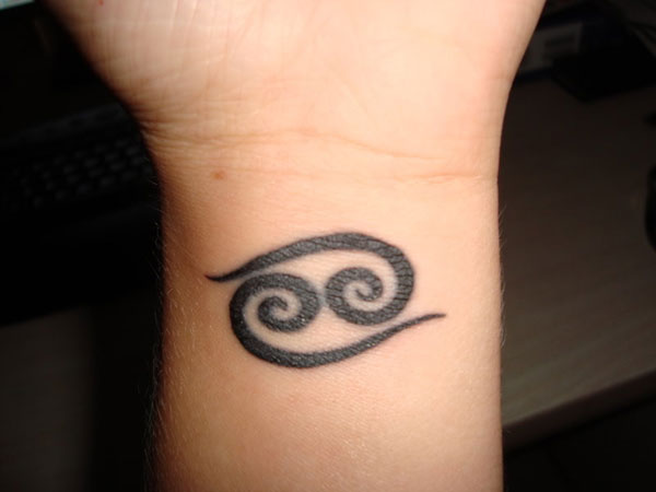 Black Tribal Spiral Tattoo On Wrist For Men