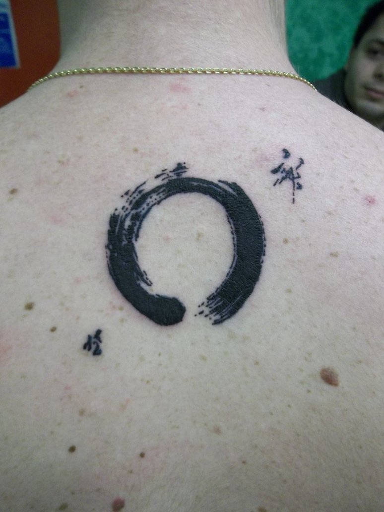 Black Zen Circle Tattoo On Man Upper Back