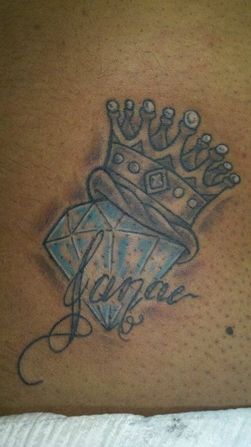 Blue Diamond With Crown Tattoo On Lower Back
