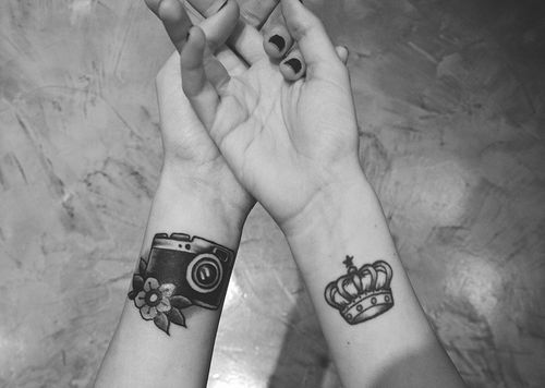 Camera And Crown Tattoos On Wrists