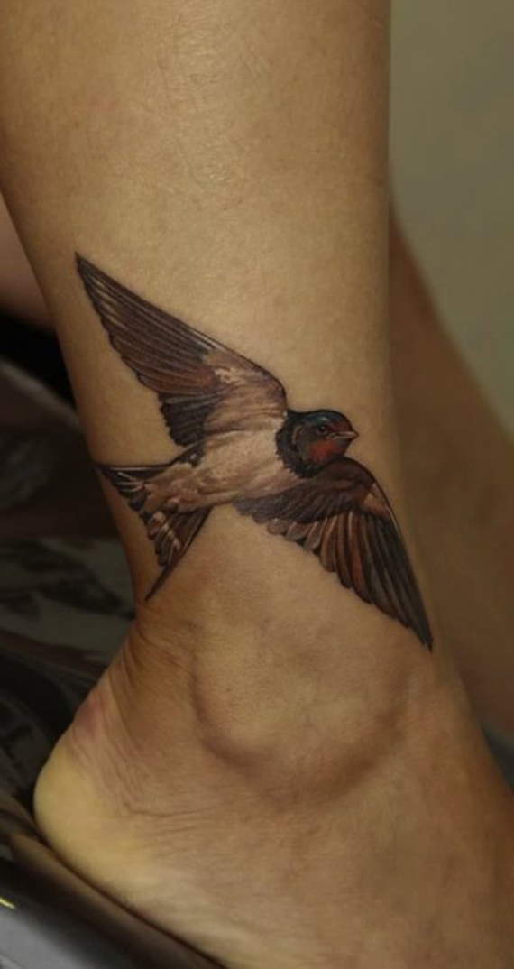 Colored Flying Bird Tattoo On Ankle
