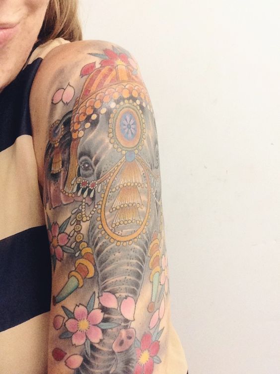 Colorful Crown On Elephant Head With Flowers Tattoo On Girl Left Half Sleeve