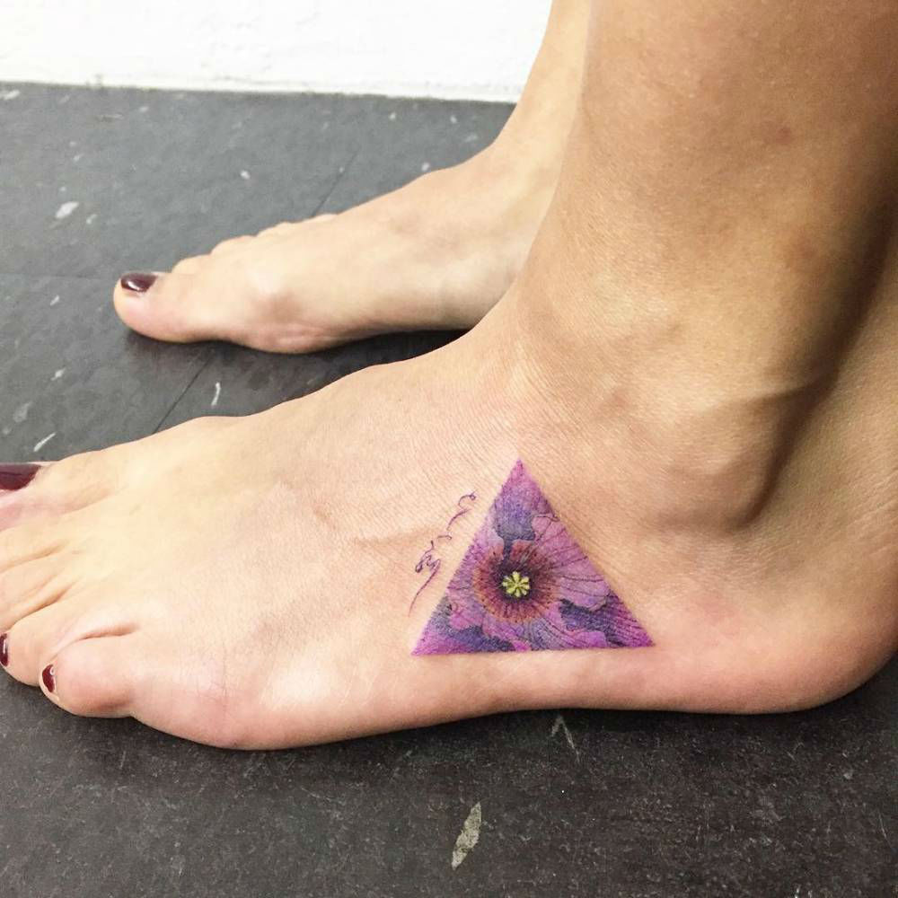 Colorful Flower In Triangle Tattoo On Girl Left Foot