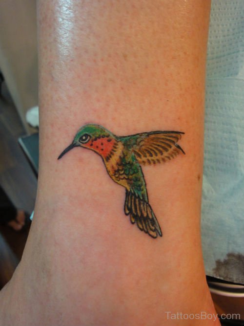 Colorful Flying Hummingbird Ankle Tattoo