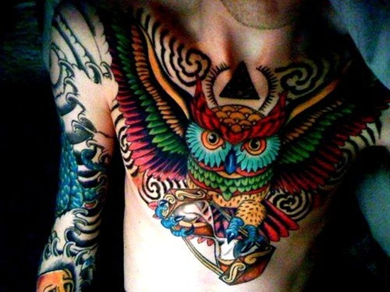 Colorful Flying Owl Tattoo On Chest