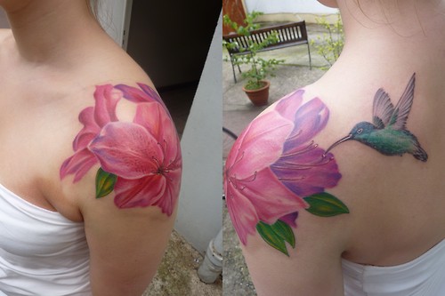 Colorful Rhododendron Flowers With Flying Bird Tattoo On Girl Left Shoulder