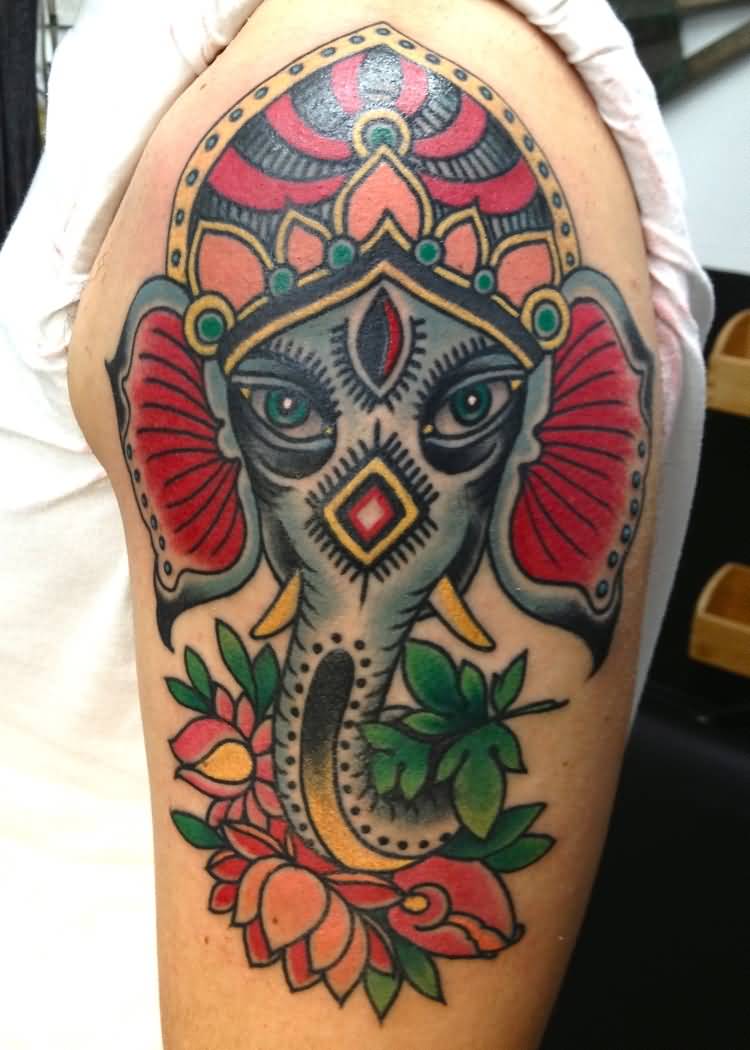 Colorful Traditional Crown On Elephant Head With Flowers Tattoo On Left Shoulder