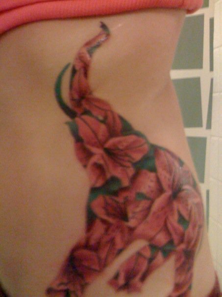 Cool Flower In Asian Elephant Trunk Up Tattoo On Girl Left Side Rib