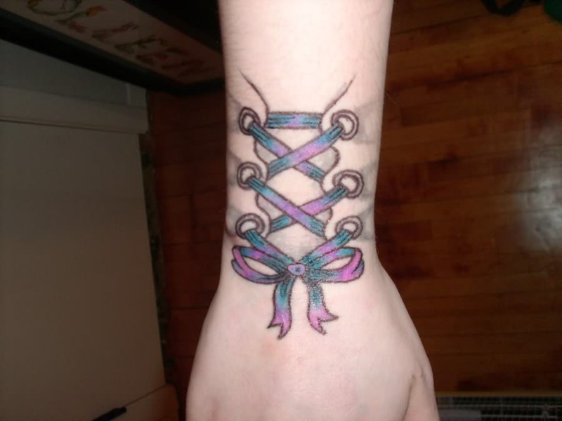 Corset Tattoo On Right Wrist For Girls