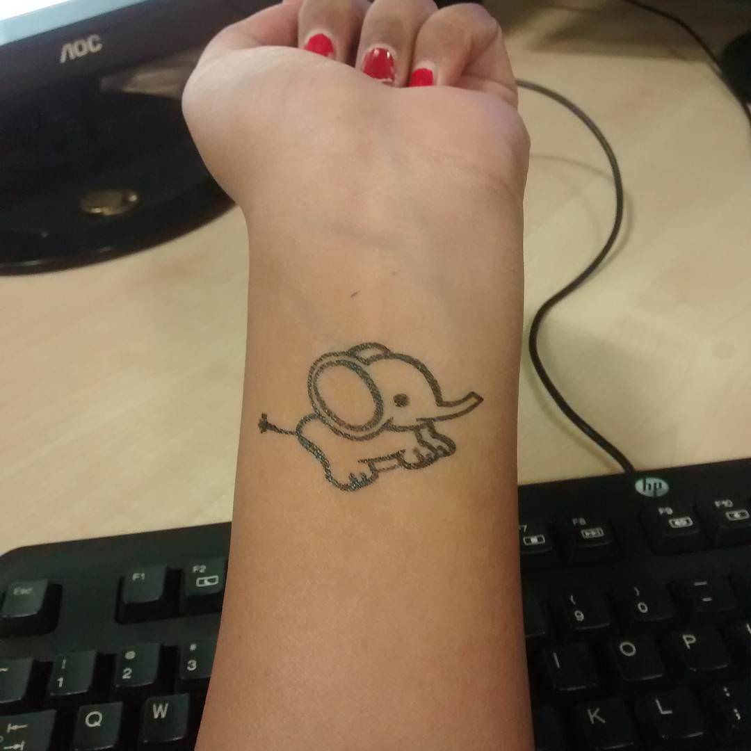 Cute Black Outline Baby Elephant Tattoo On Girl Left Wrist