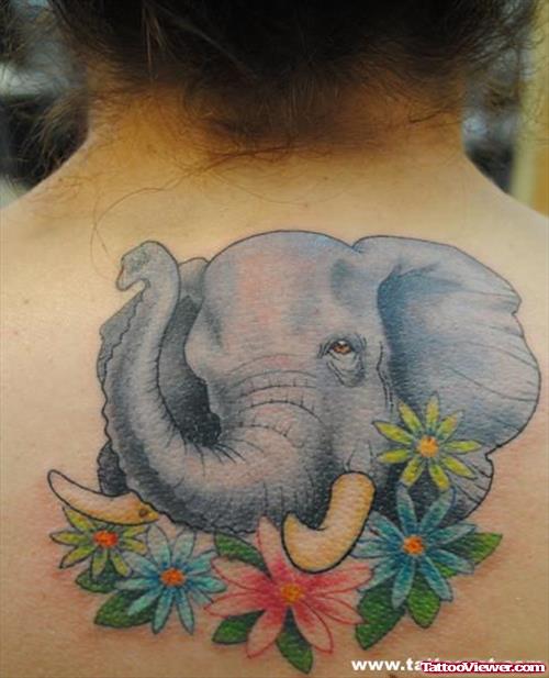 Cute Elephant Head With Flowers Tattoo On Upper Back