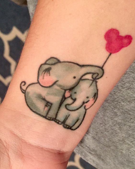 Cute Two Baby Elephants With Balloon Tattoo On Wrist
