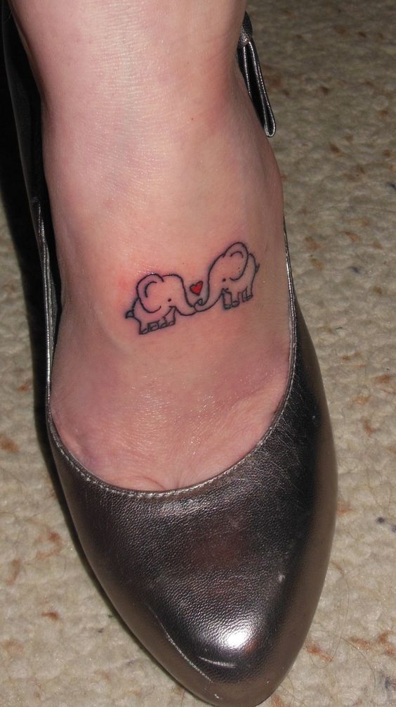 Cute Two Baby Elephants With Heart Tattoo On Left Foot