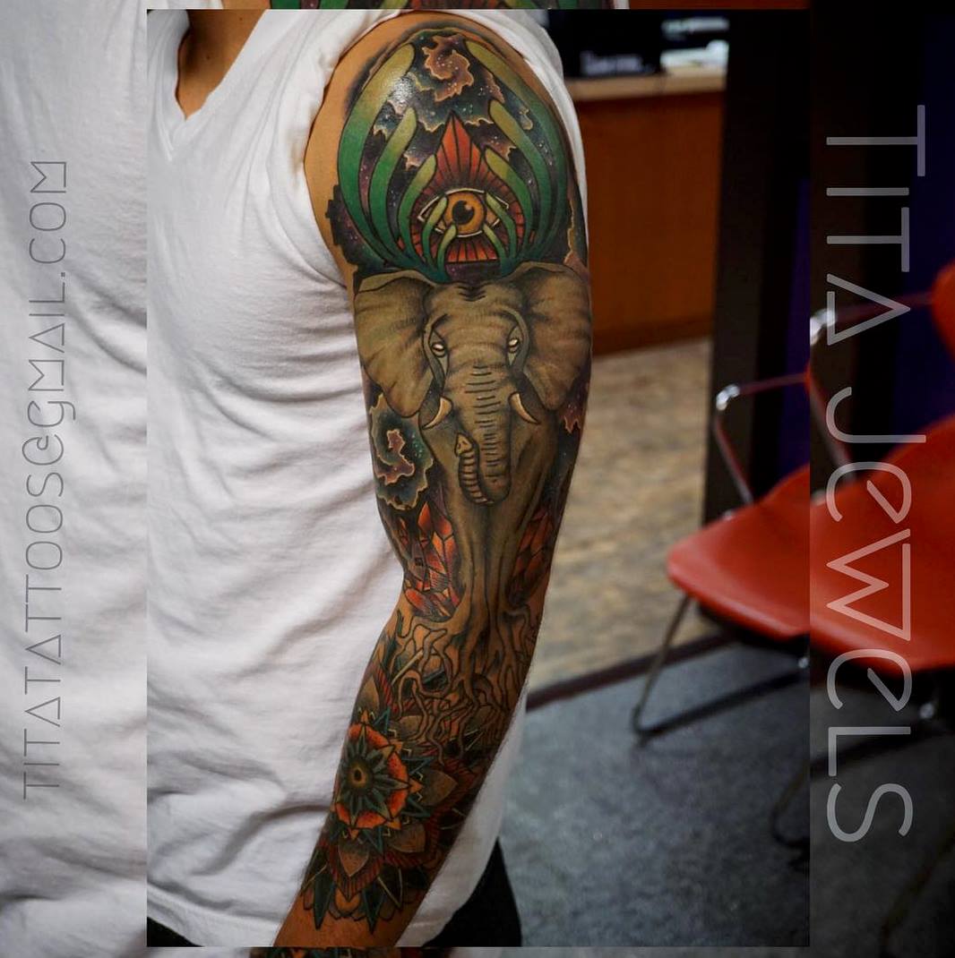 Elephant With Illuminati Eye And Flowers Tattoo On Left Full Sleeve