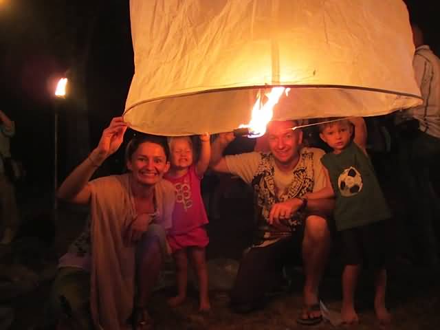 Family Trying To Release Lantern During Yi Peng Festival