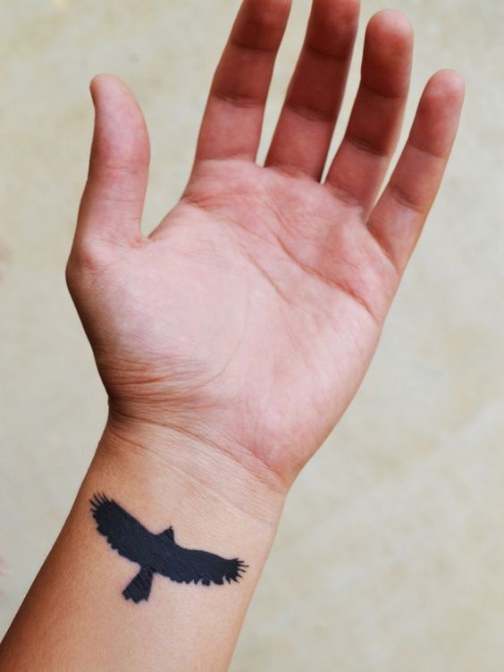 Flying Black Crow Tattoo On Wrist For Men