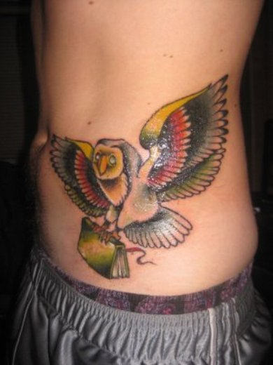 Flying Owl With Book In Claws Tattoo On Side Rib