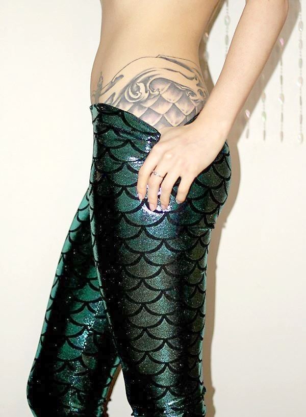Girl Showing Her Mermaid Scale Tattoo On Side Leg