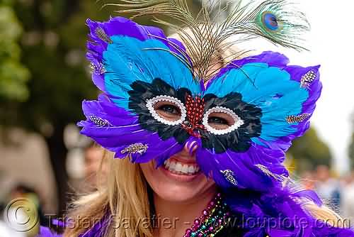 Girl Wearing Feathered Mardi Gras Mask