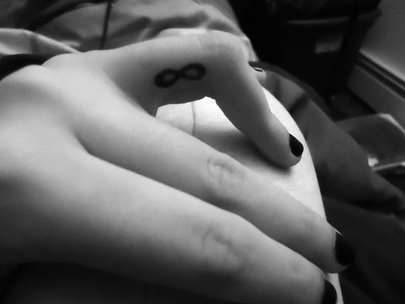 Girl With Infinity Side Finger Tattoo