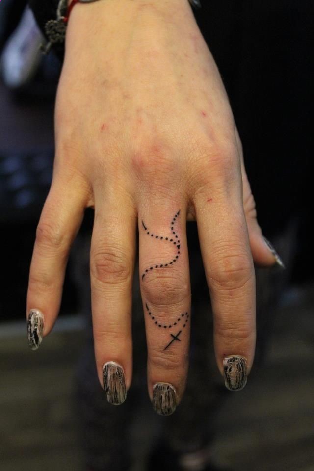 Girl With Rosary Tattoo On Finger