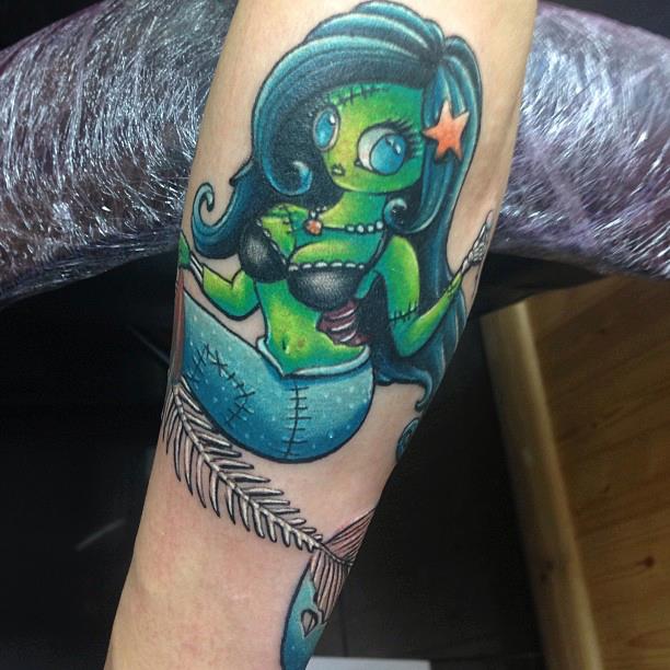 Green Ink Little Mermaid Tattoo On Left Sleeve