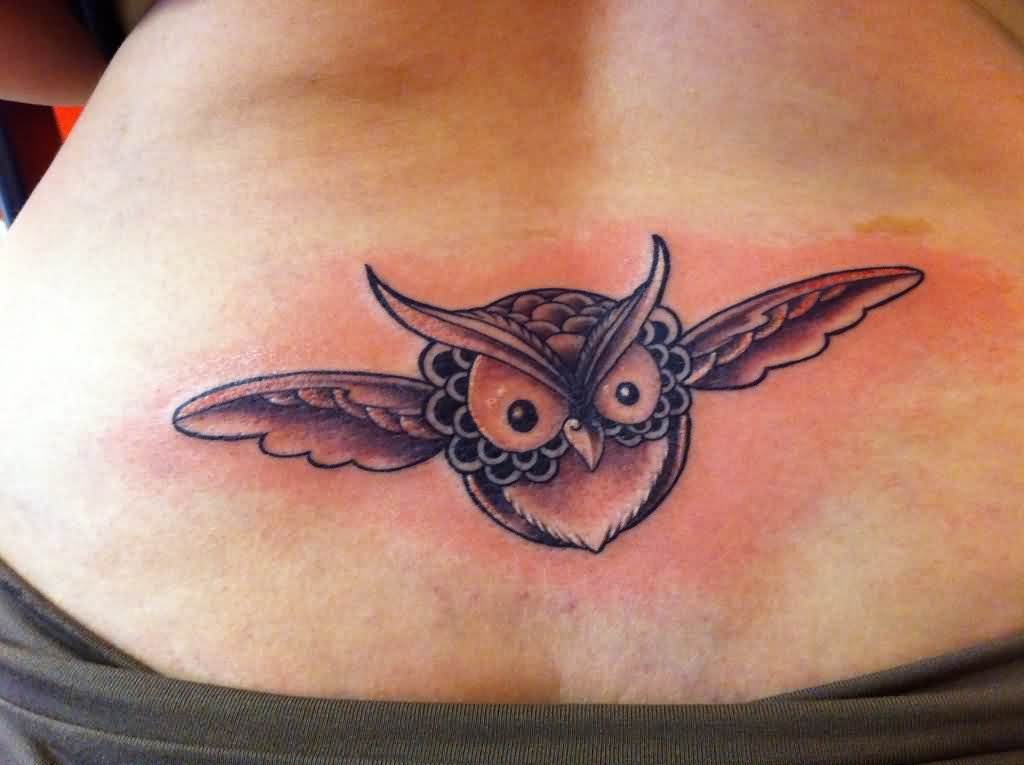 Grey Ink Baby Owl Flying Tattoo On Lower Back