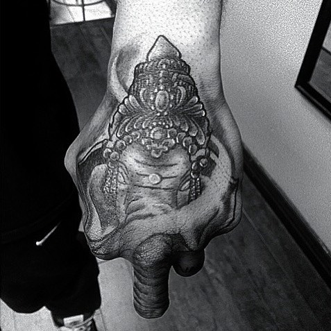 Grey Ink Crown On Elephant Head Tattoo On Left Hand