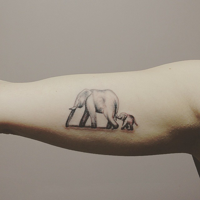 Grey Ink Elephant Family Tattoo On Bicep