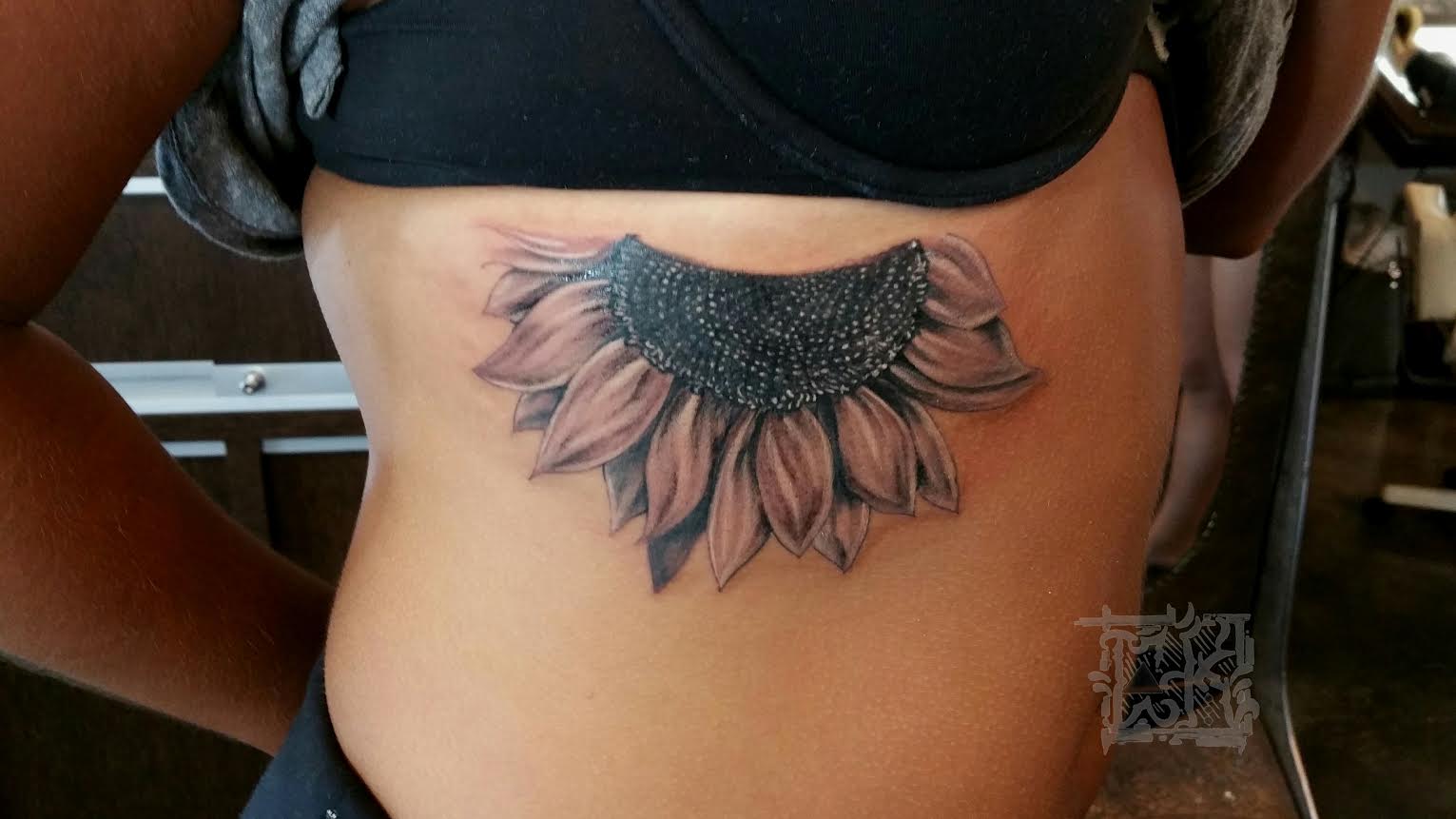 Grey Ink Realistic Sunflower Tattoo On Side Rib