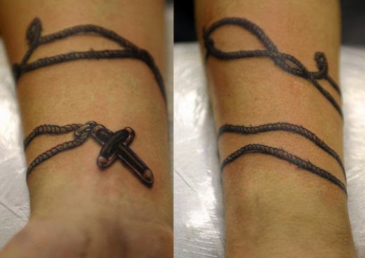 Grey Ink Rosary Cross Tattoo On Wrist For Men