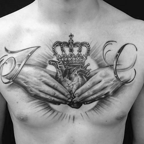 Human Heart In Hands With Crown Tattoo On Man Chest