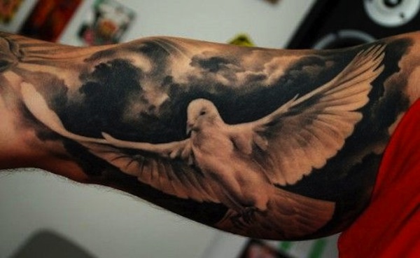 Inner Bicep Flying Dove Tattoo With Clouds
