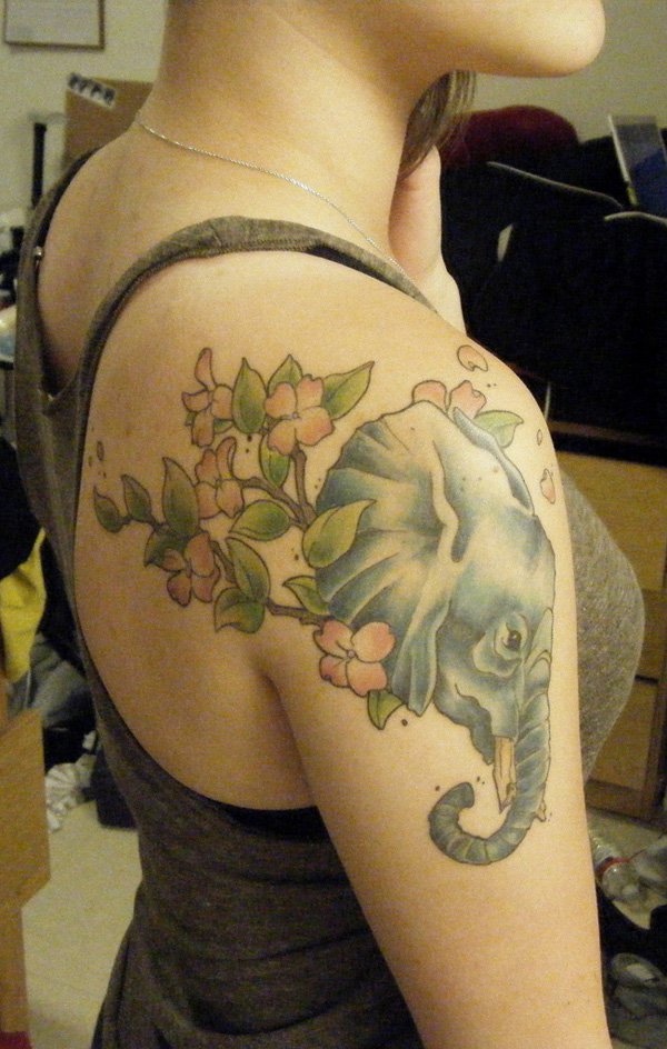 Latest Asian Elephant Head With Flowers Tattoo On Girl Right Shoulder