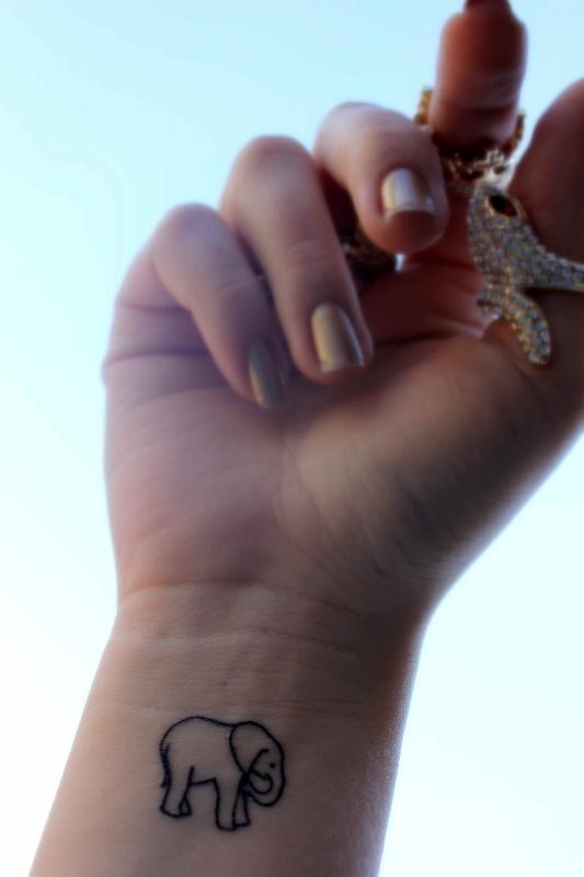 Latest Black Outline Elephant Tattoo On Girl Right Wrist