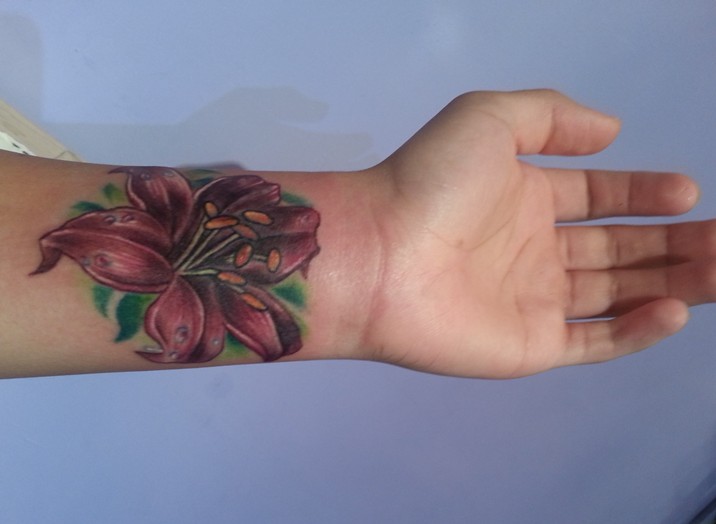 Lily Flower Tattoo On Girl Left Wrist