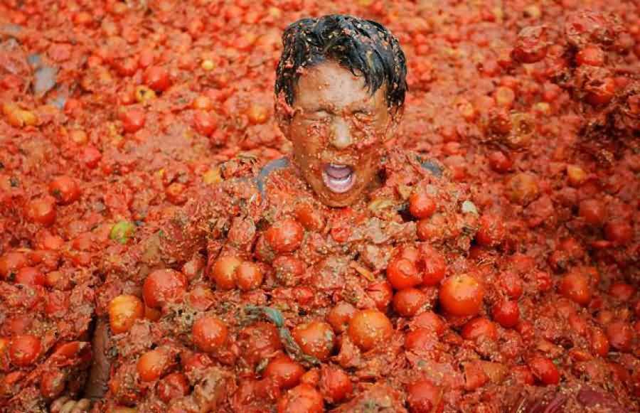 Man Covered With Tomatoes During La Tomatina Festival Celebration