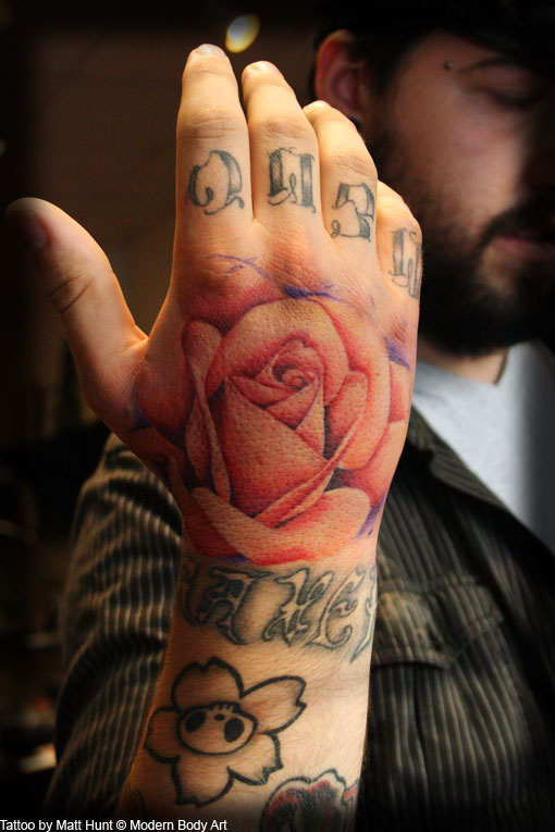 Man Showing His Pink Rose Tattoo On Right Hand