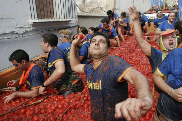 Men Throwing Tomatoes During La Tomatina Festival Celebration