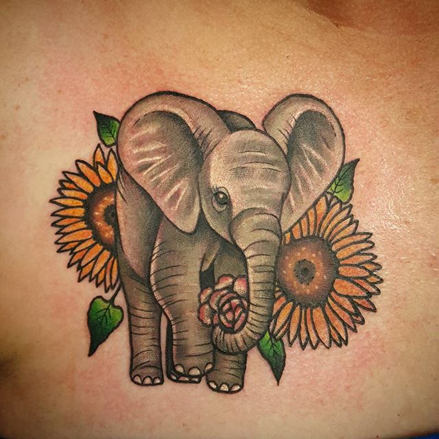 Mind Blowing Elephant With Flowers Tattoo Design