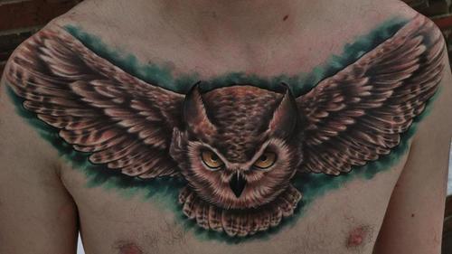 Nice Flying Owl Tattoo On Man Chest