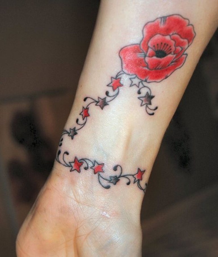 Orange Stars And Flower Wrist Tattoo