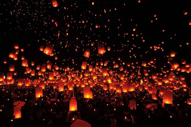 People Releasing Lanterns In The Sky During Yi Peng Celebration In Thailand
