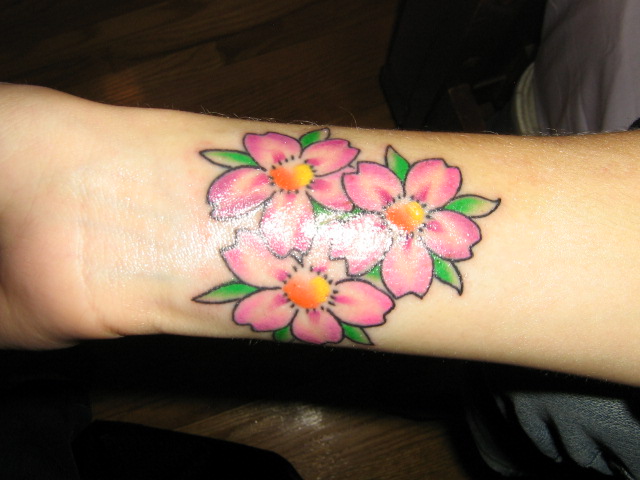 Pink Flowers Tattoos On Girl Right Wrist