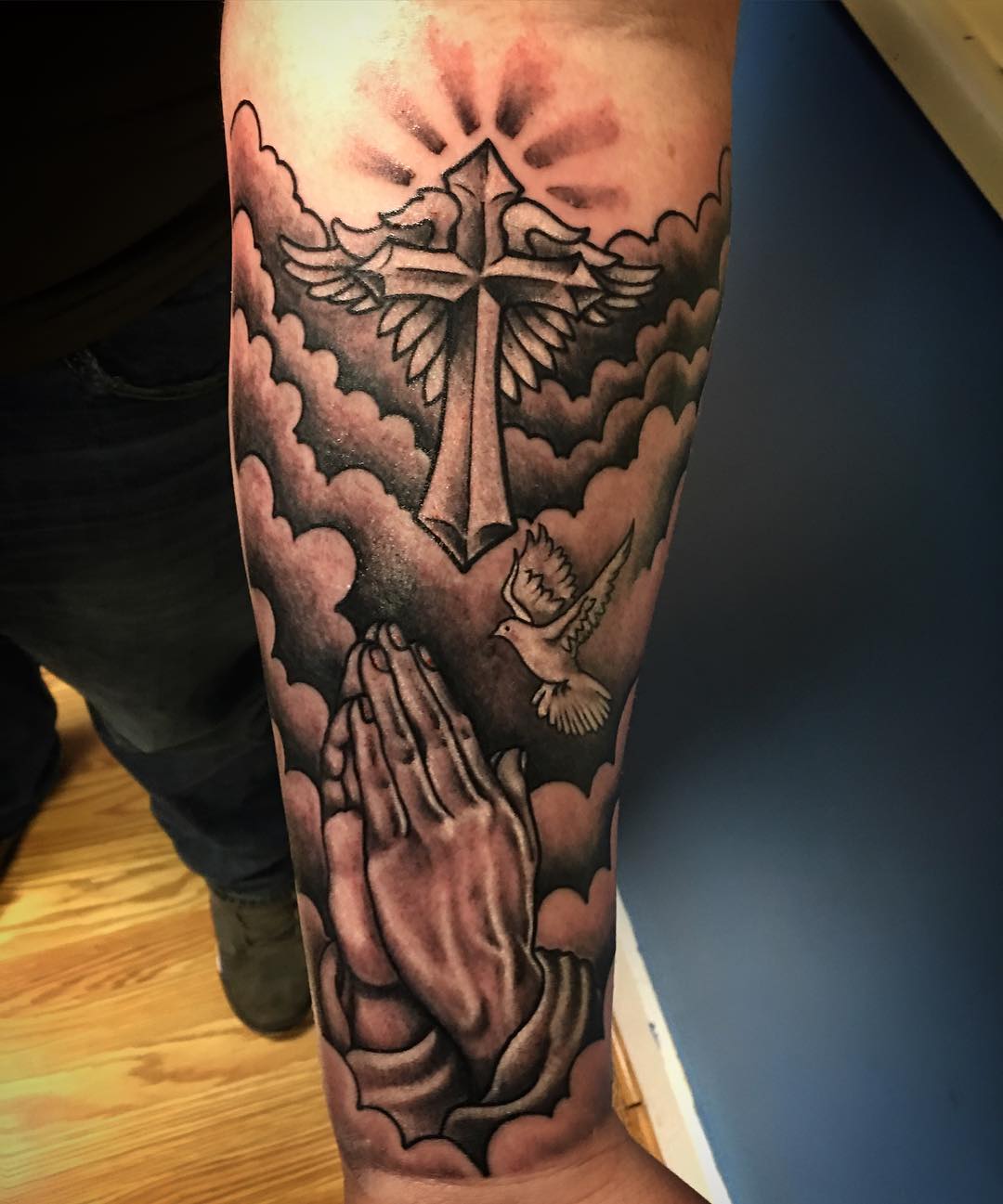 Praying Hands with Cross And Flying Dove With Clouds Tattoo On Forearm