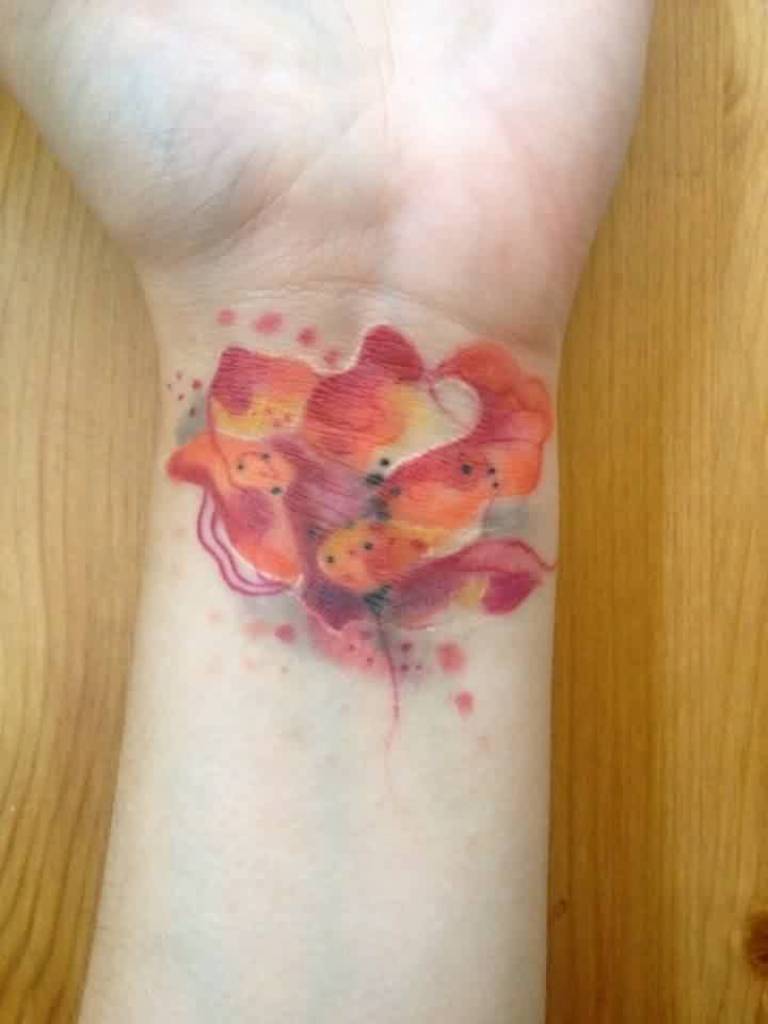 Red And Orange Flower Tattoo On Wrist